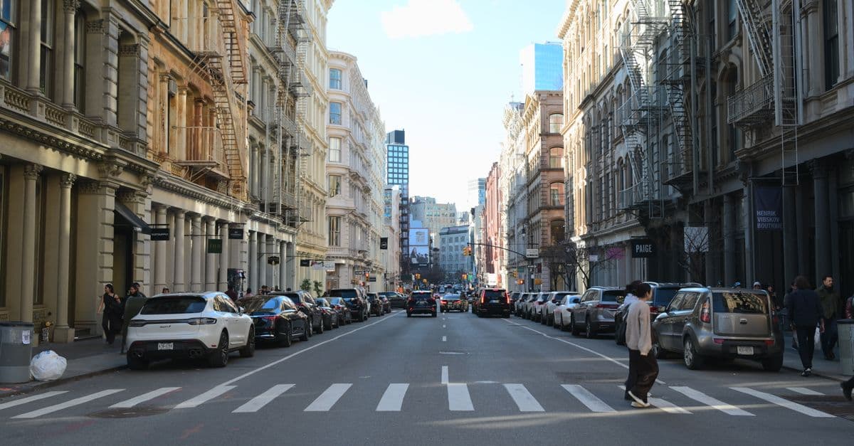 Serene moment on a bustling SoHo street in NYC, featuring classic architecture.